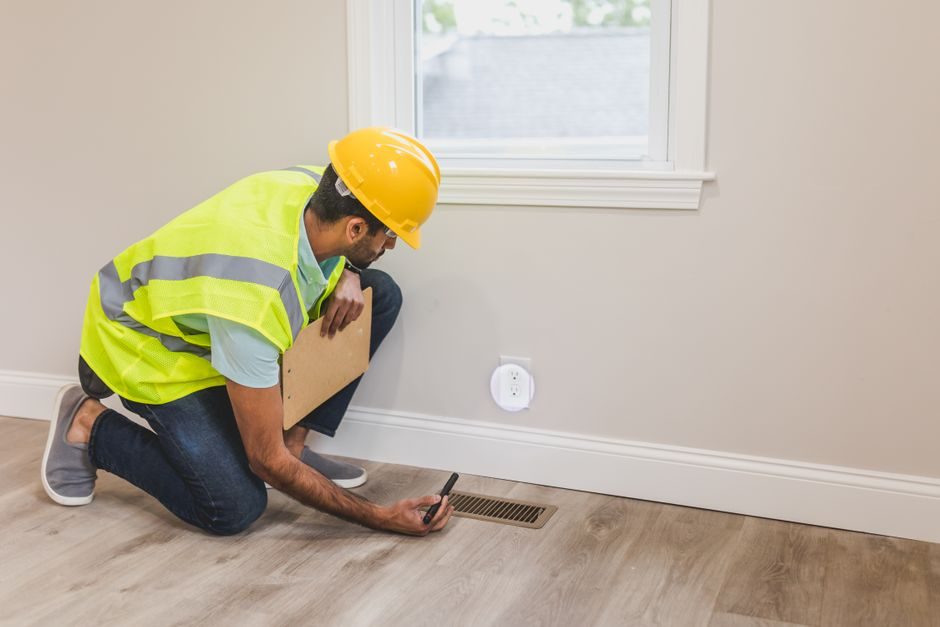 Technician installing new HVAC equipment in a Miami home