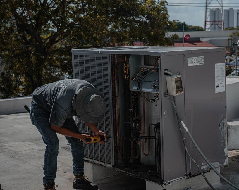 Ice Team technician repairing an air conditioning unit on a Miami rooftop