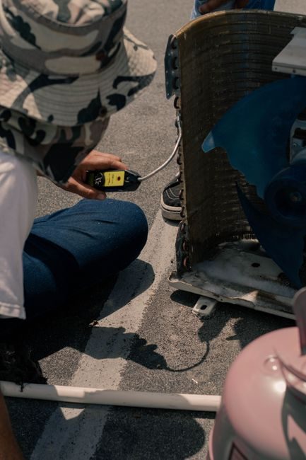 Close-up of an Ice Team technician's hands working on air conditioning wiring